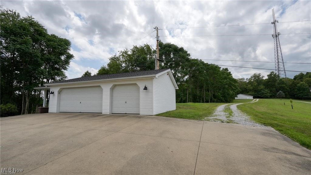 66333 Read Road Cambridge, OH 43725 - Photo 16 of 49 Garage with a lawn