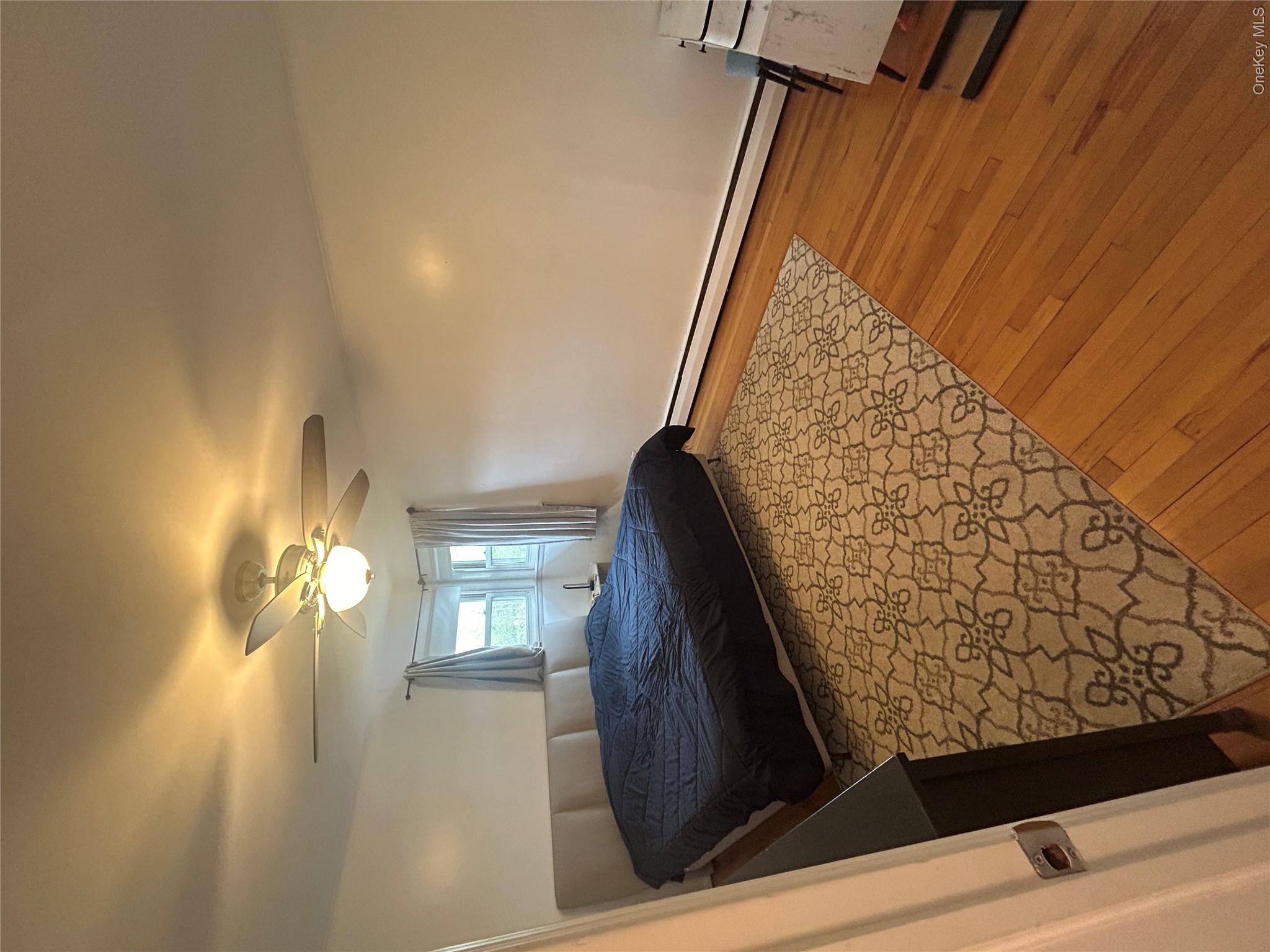 10 Kings Park Road Commack, NY 11725 - Photo 12 of 29 a bedroom with a bed and a window