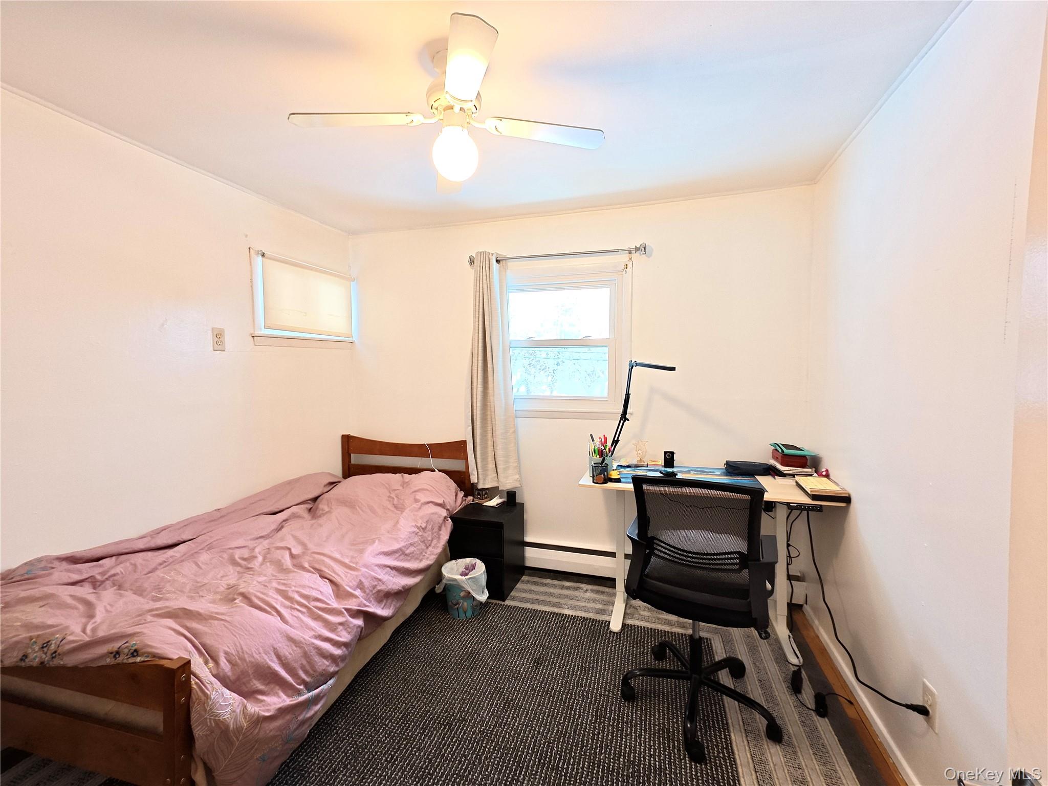 10 Kings Park Road Commack, NY 11725 - Photo 13 of 29 a bedroom with a bed and a desk
