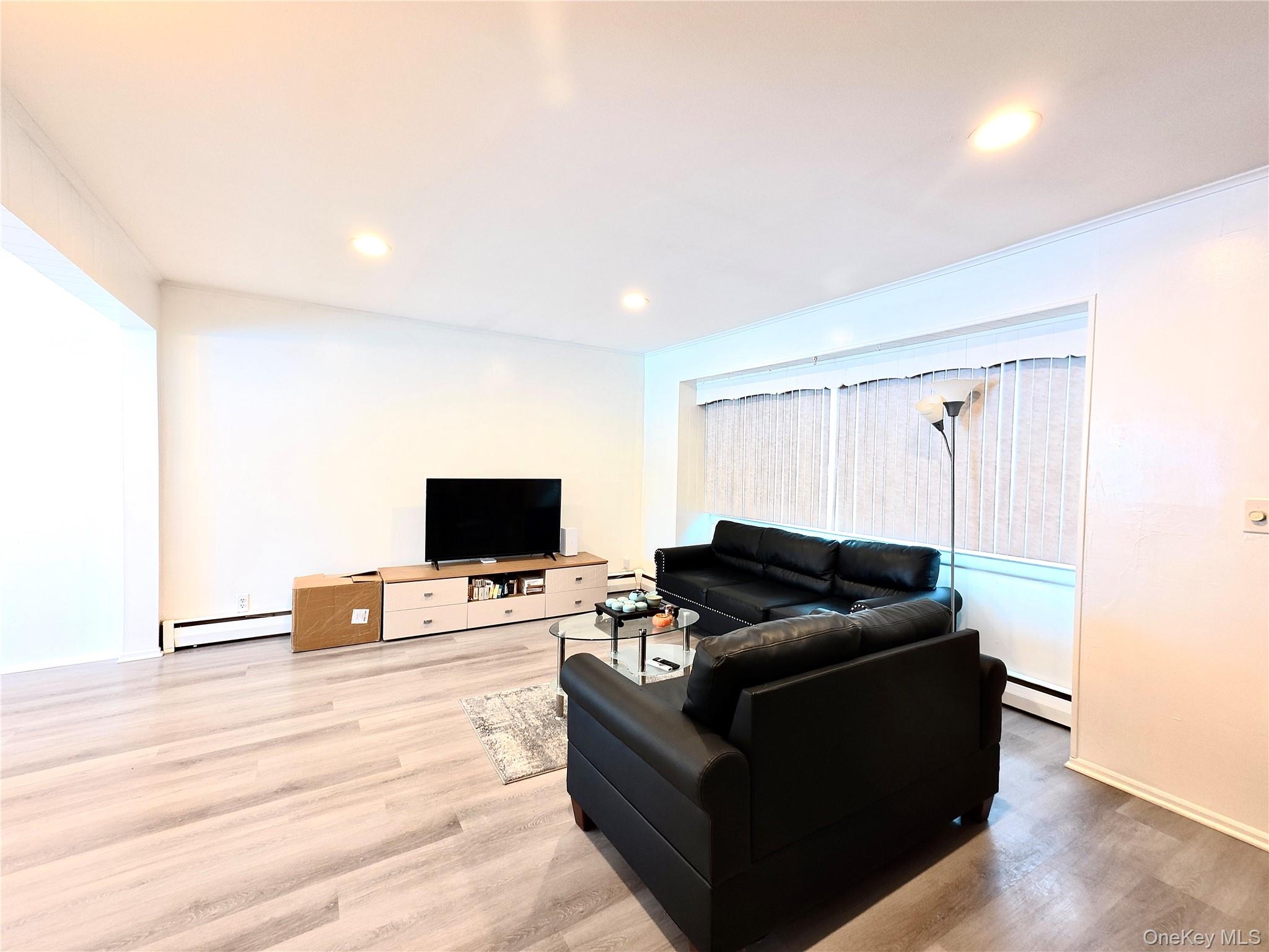 10 Kings Park Road Commack, NY 11725 - Photo 2 of 29 a living room with furniture and a flat screen tv