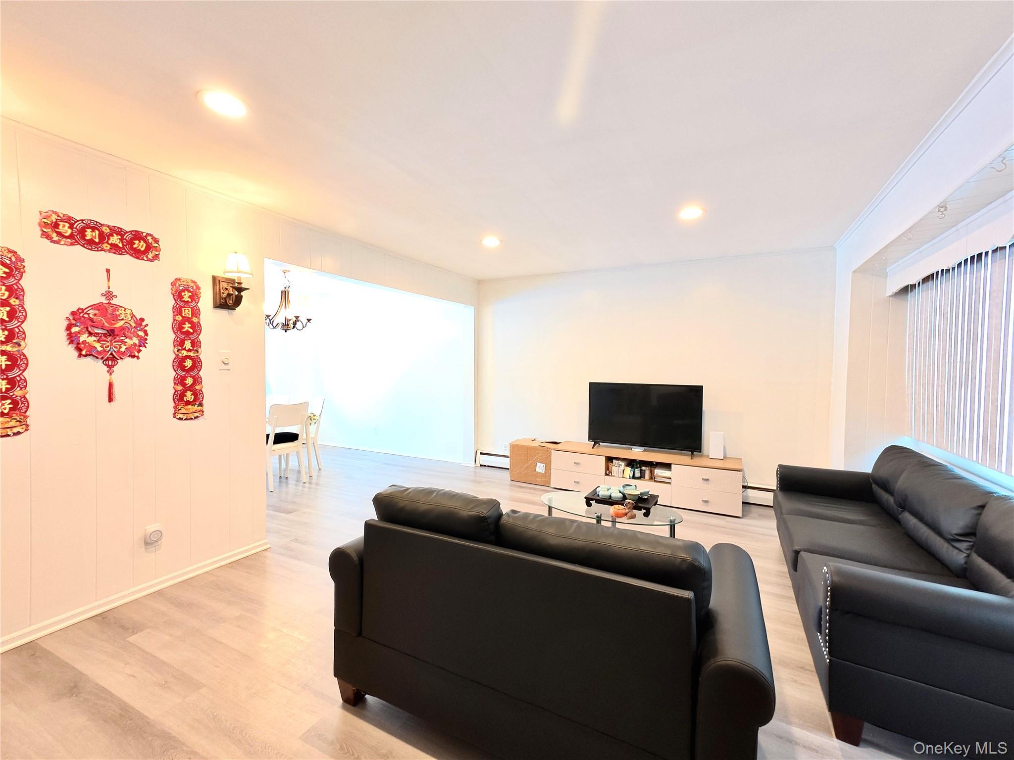 10 Kings Park Road Commack, NY 11725 - Photo 3 of 29 a living room with furniture and a flat screen tv