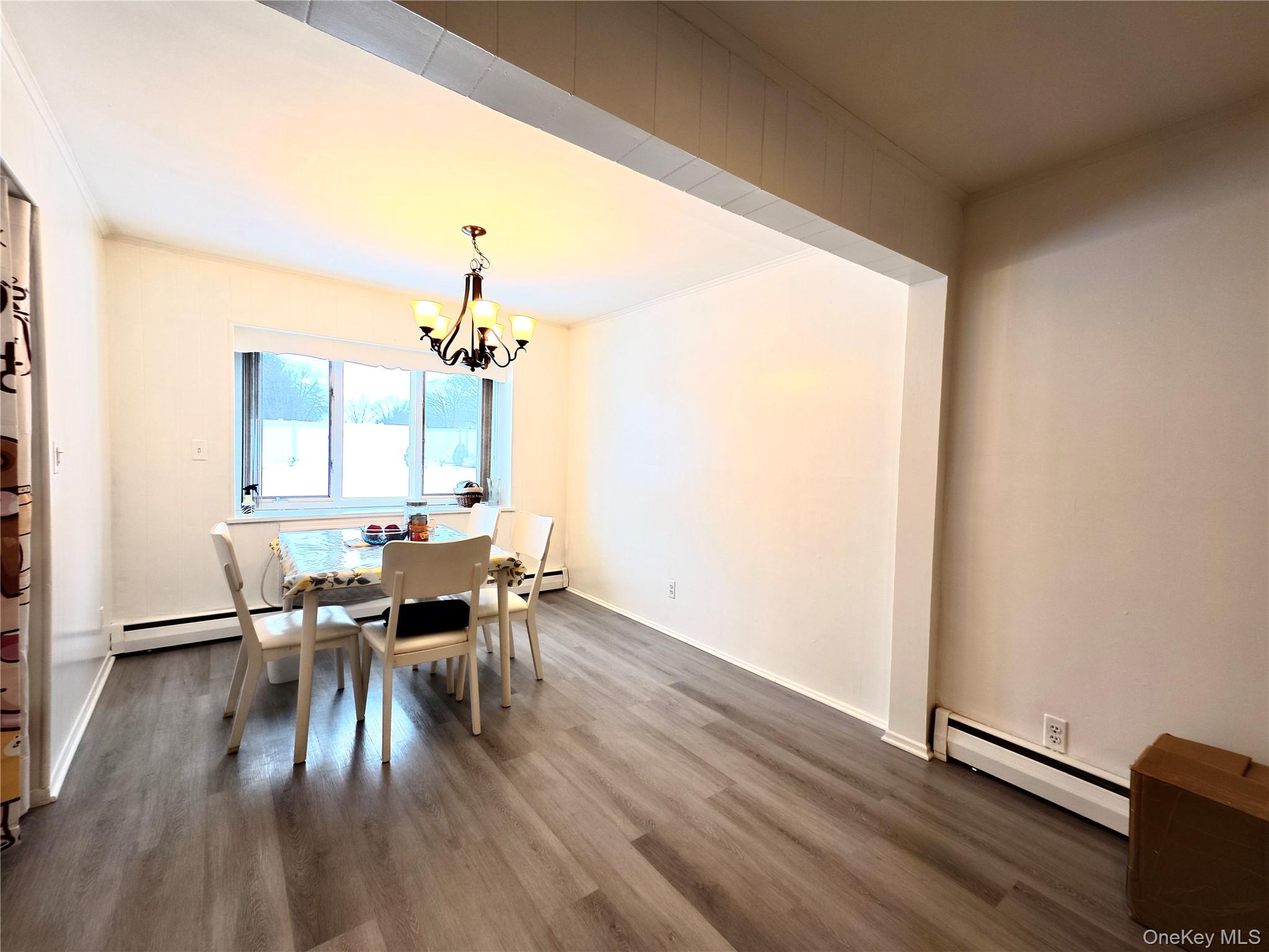 10 Kings Park Road Commack, NY 11725 - Photo 4 of 29 a view of a dining room with furniture and wooden floor
