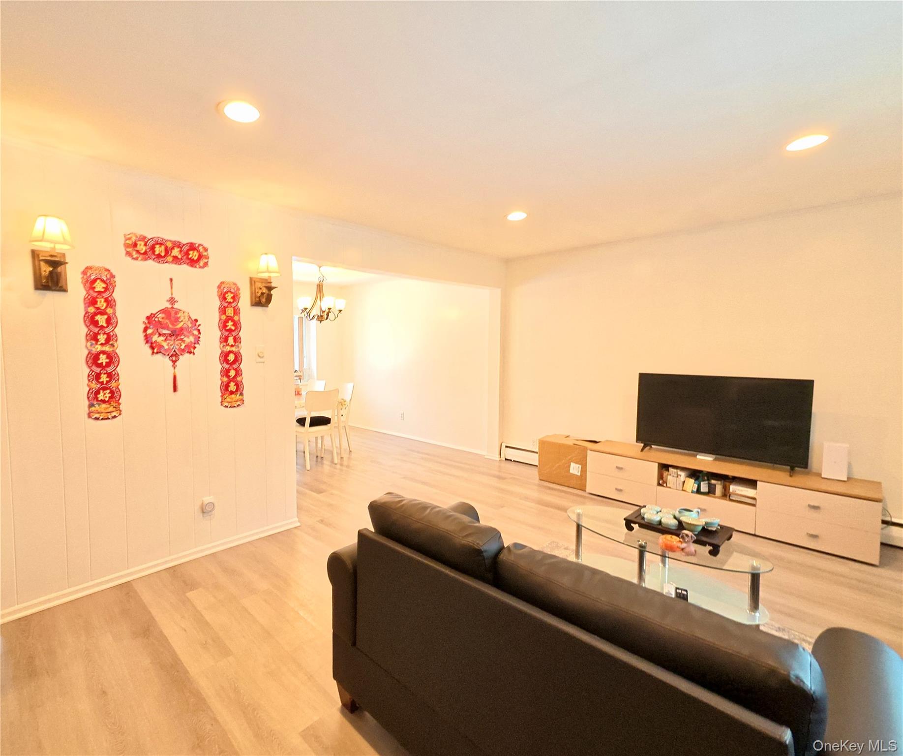 10 Kings Park Road Commack, NY 11725 - Photo 6 of 29 a living room with furniture and a flat screen tv