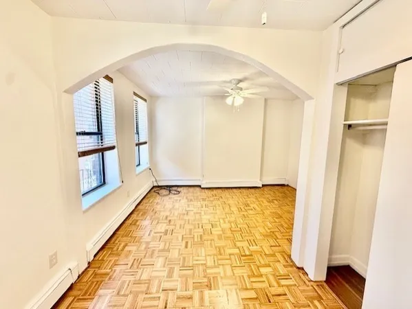 a view of a livingroom with a ceiling fan and window