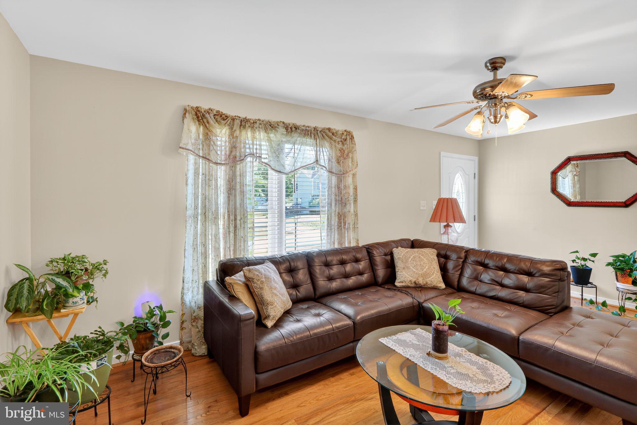 330 Powder Horn Drive Ruther Glen, VA 22546 - Photo 3 of 26 Cozy living room with warm hardwood floors