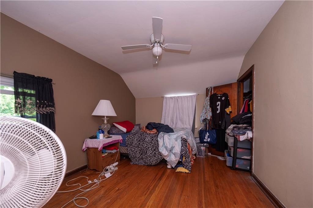 44 Forest Grove Road Coraopolis, PA 15108 - Photo 16 of 29 a bed room with a bed and a chandelier