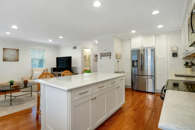 a kitchen that has a lot of cabinets a sink and a refrigerator