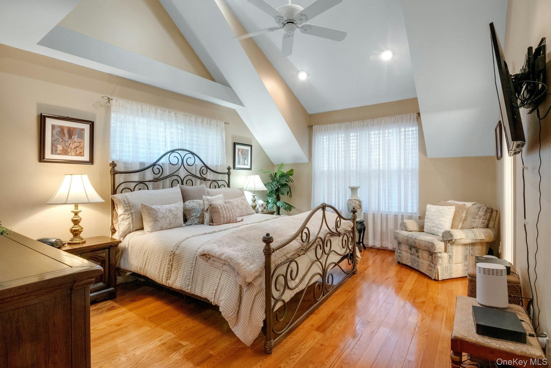 118 Underhill Lane Peekskill, NY 10566 - Photo 18 of 33 Spacious primary bedroom with ensuite bathroom, walk-in closet, vaulted ceilings and wood floors.