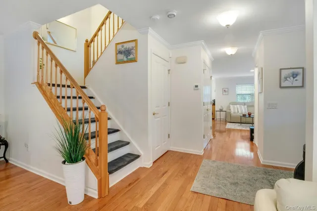 a view of entryway and hall with wooden floor