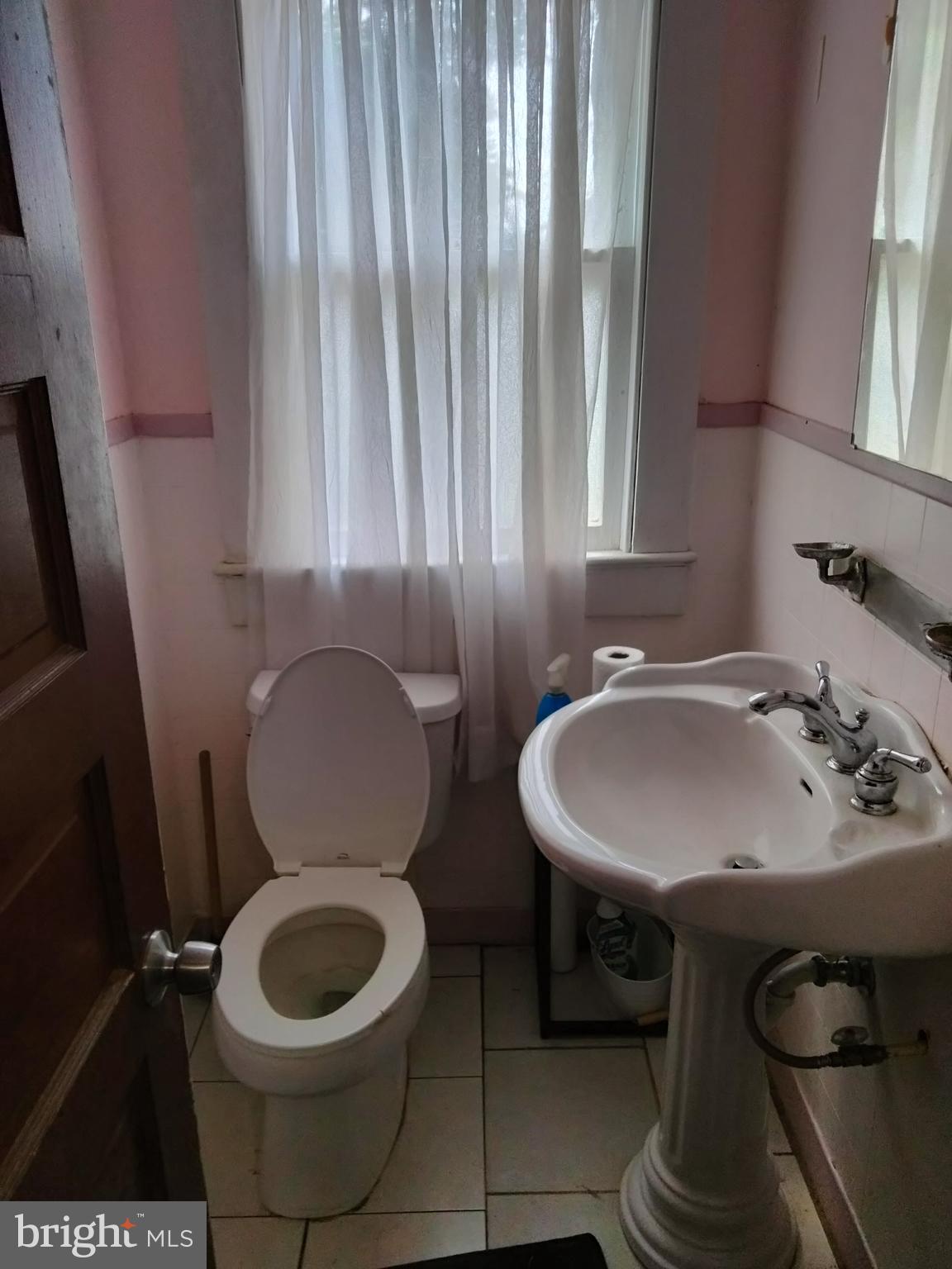 7411 Main Street Willards, MD 21874 - Photo 32 of 43 a bathroom with a sink a toilet and a mirror
