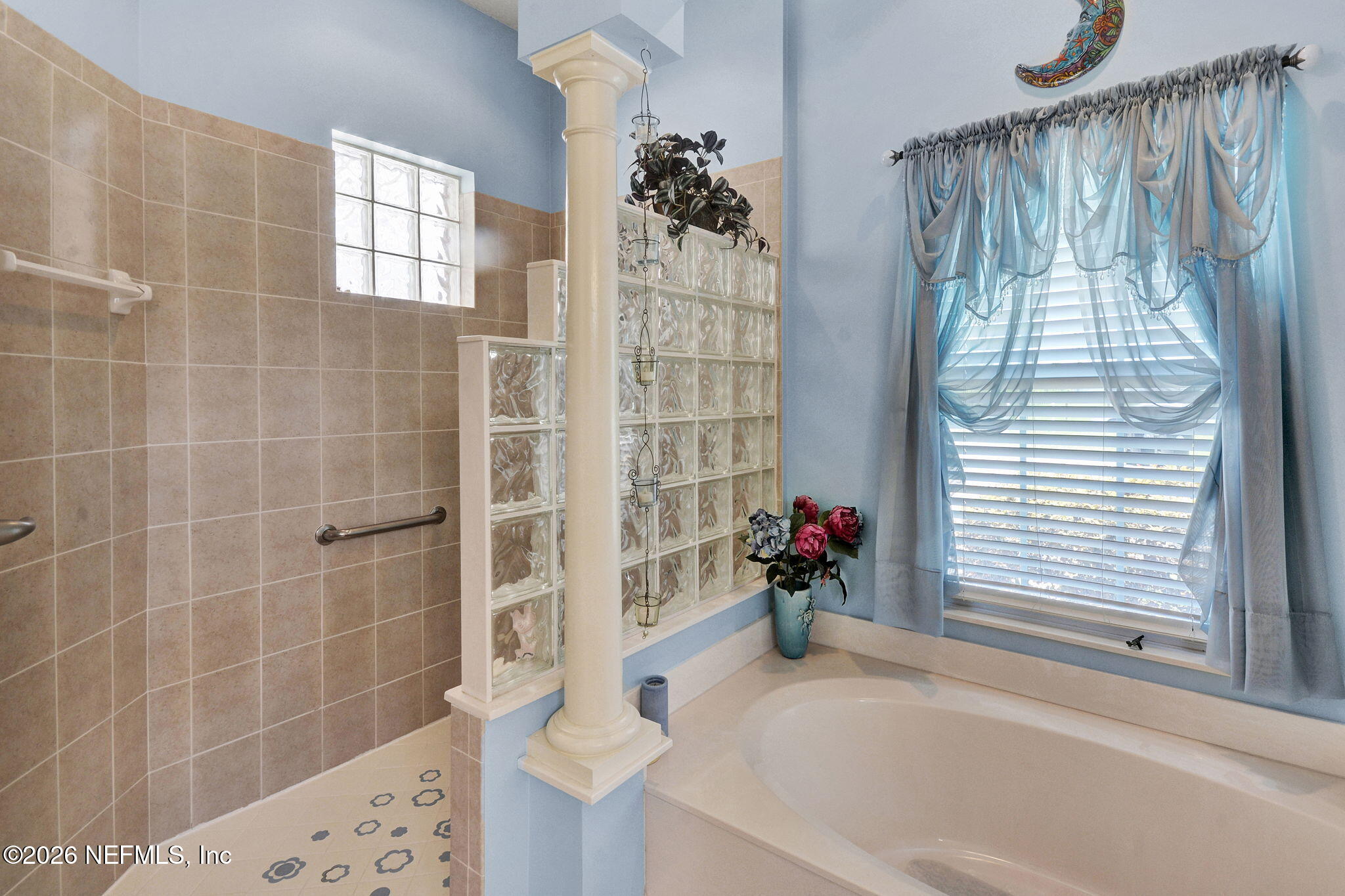5950 West Shores Road Orange Park, FL 32003 - Photo 27 of 42 a bath room with a bathtub and shower
