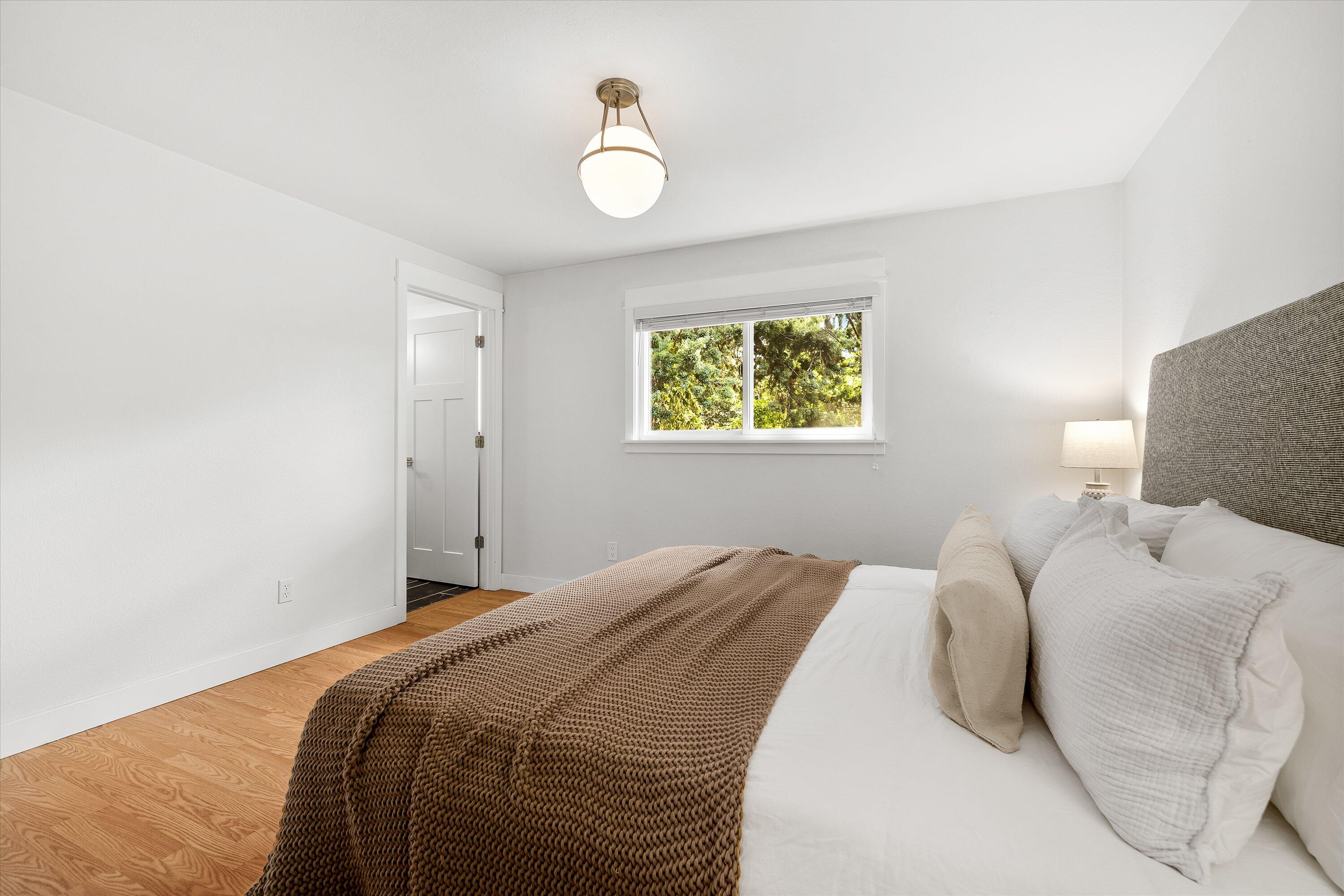 63634 Hunters Circle Bend, OR 97701 - Photo 12 of 28 a bedroom with a bed and a chandelier