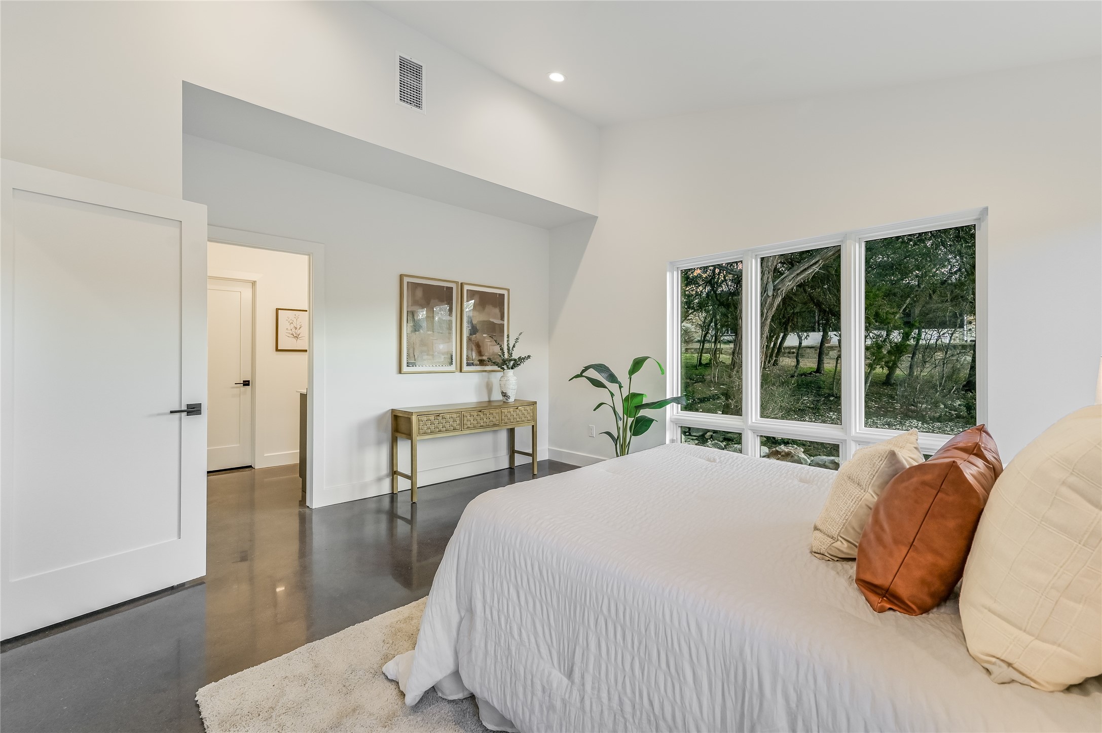 321 Tulley Court Wimberley, TX 78676 - Photo 18 of 29 a bedroom with a bed a table and painting