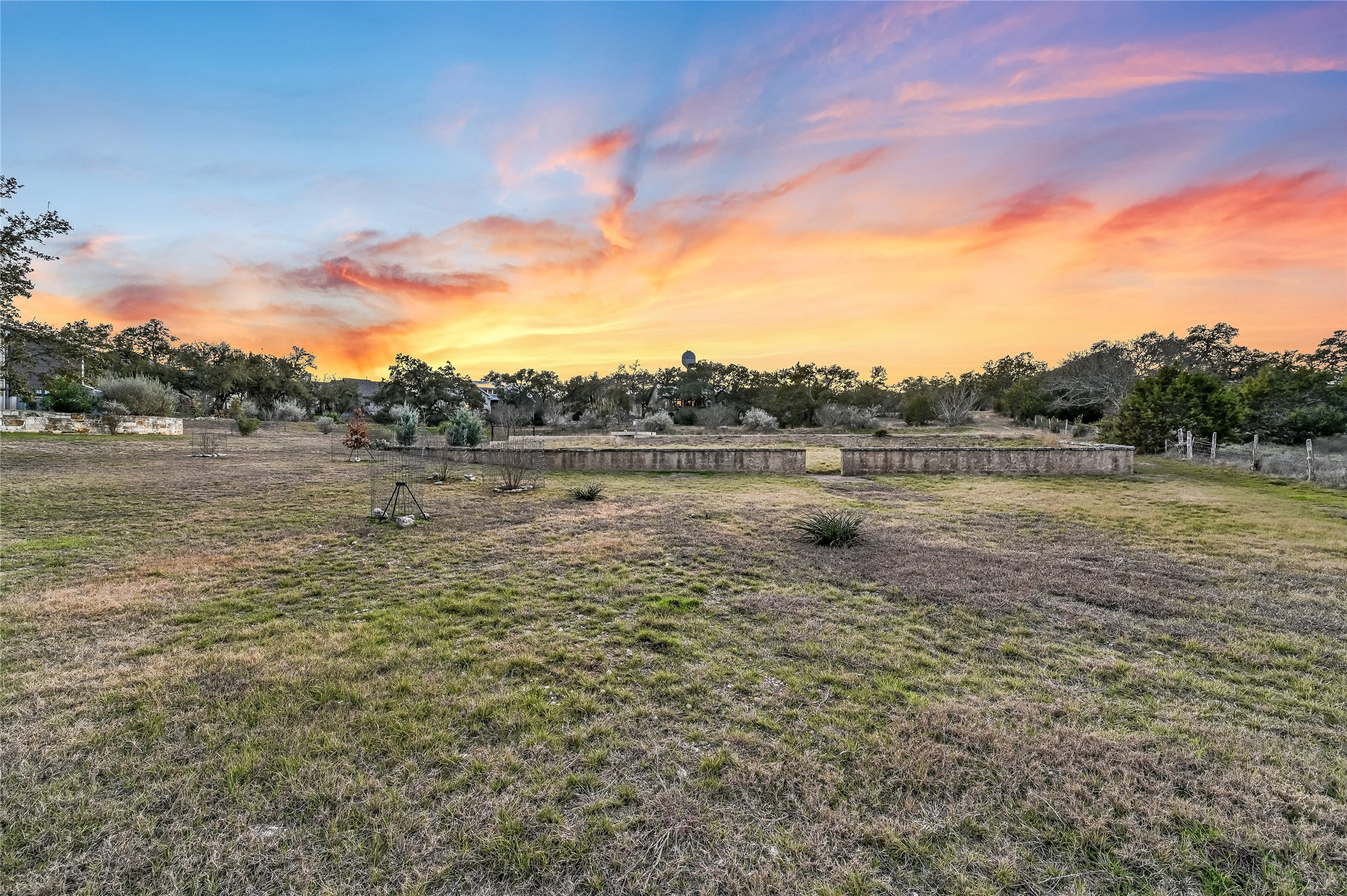 321 Tulley Court Wimberley, TX 78676 - Photo 25 of 29 a view of a lake with houses in the background