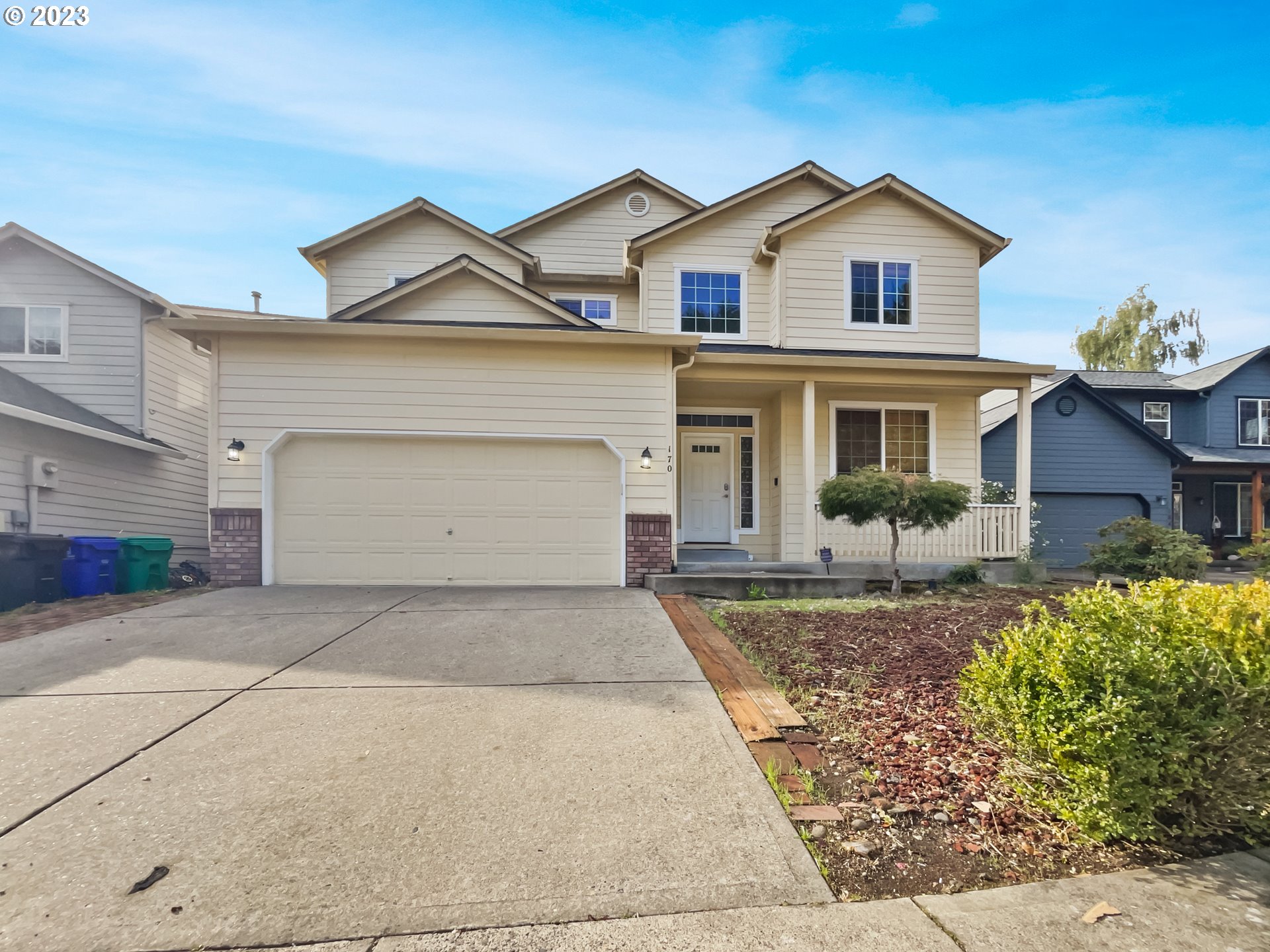 a front view of a house with a yard and garage
