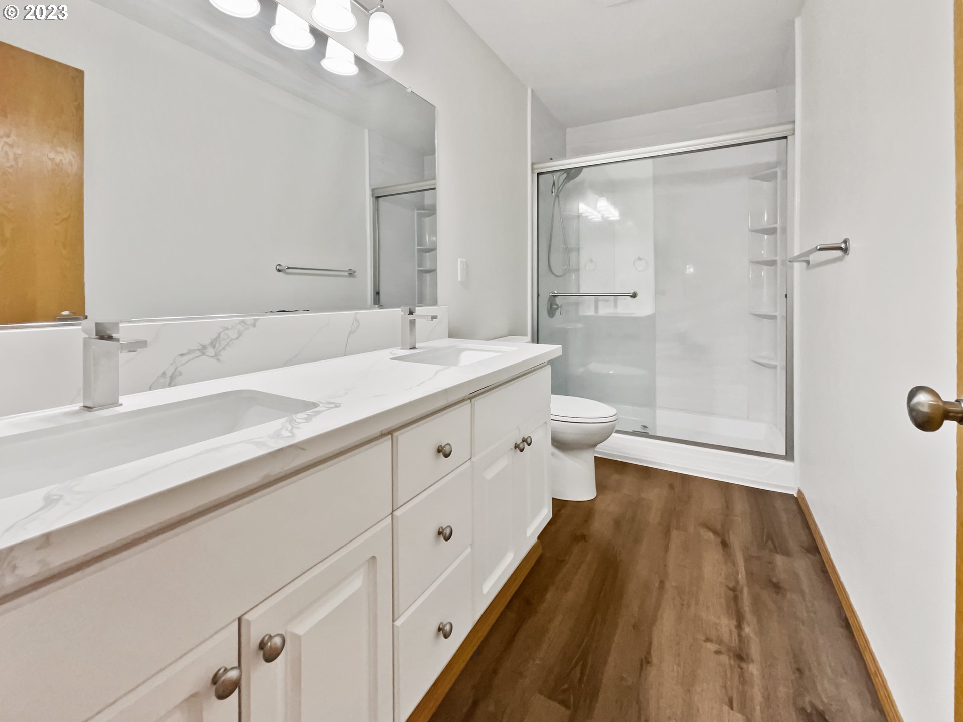 170 Southwest Sandlewood Loop Gresham, OR 97030 - Photo 17 of 19 a spacious bathroom with a double vanity sink a toilet and a mirror