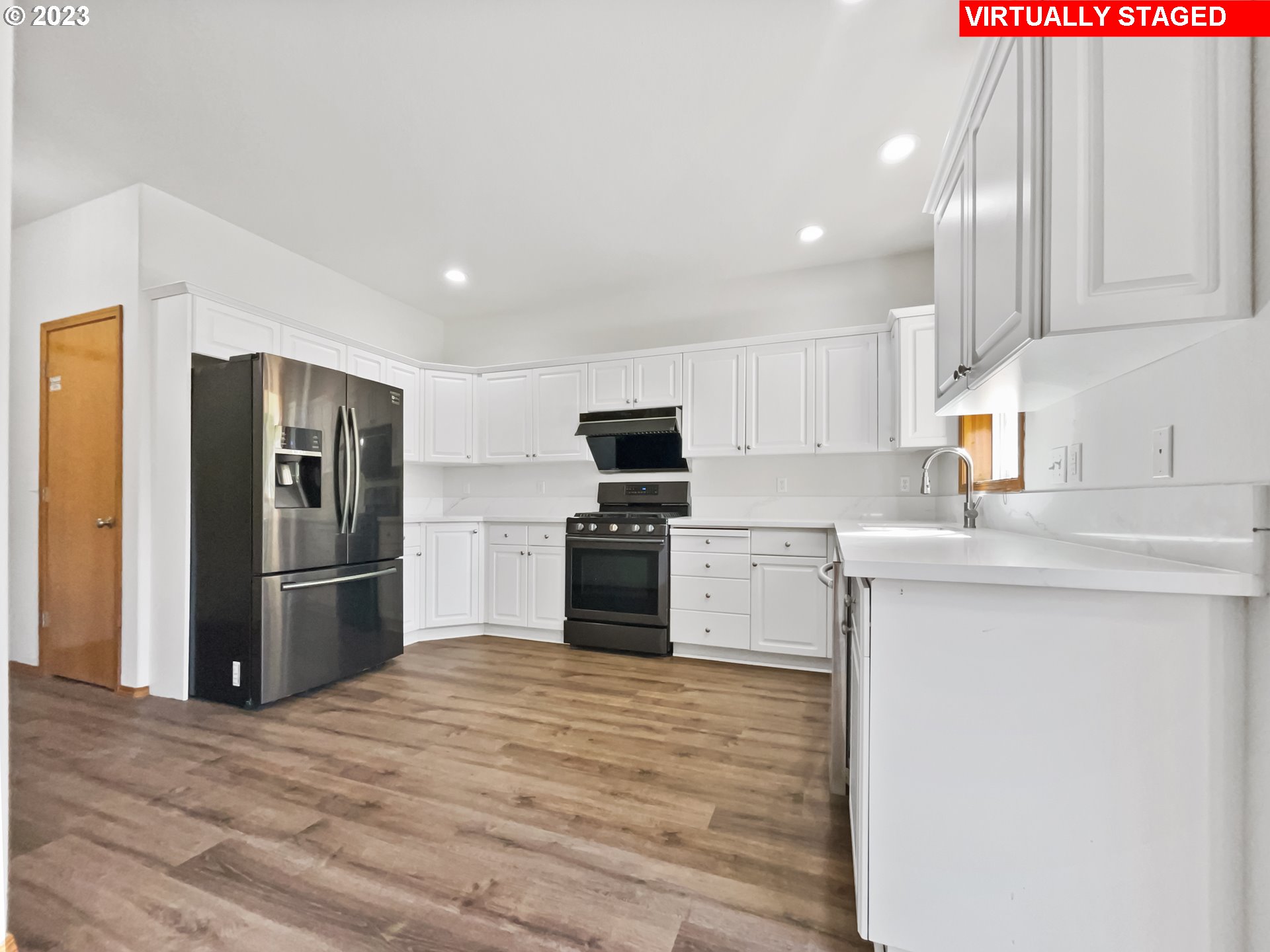 170 Southwest Sandlewood Loop Gresham, OR 97030 - Photo 4 of 19 a kitchen with granite countertop a refrigerator and a sink