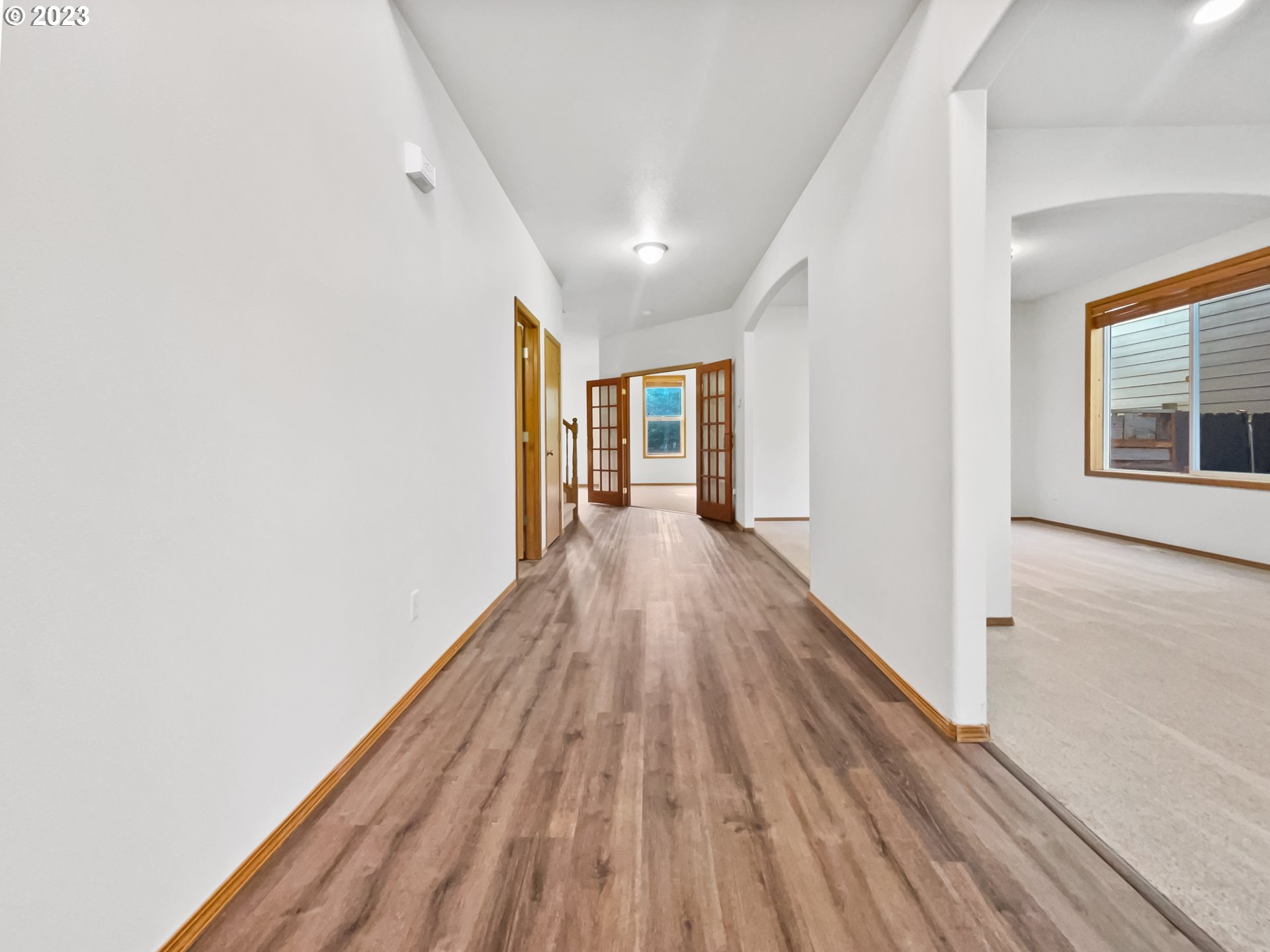 170 Southwest Sandlewood Loop Gresham, OR 97030 - Photo 5 of 19 a view of a hallway with wooden floor