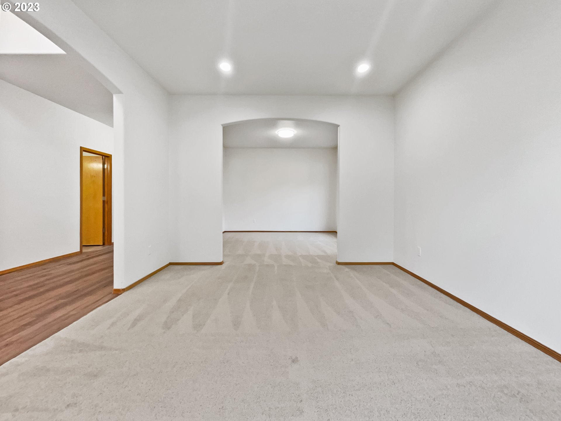 170 Southwest Sandlewood Loop Gresham, OR 97030 - Photo 6 of 19 an empty room with wooden floor and windows