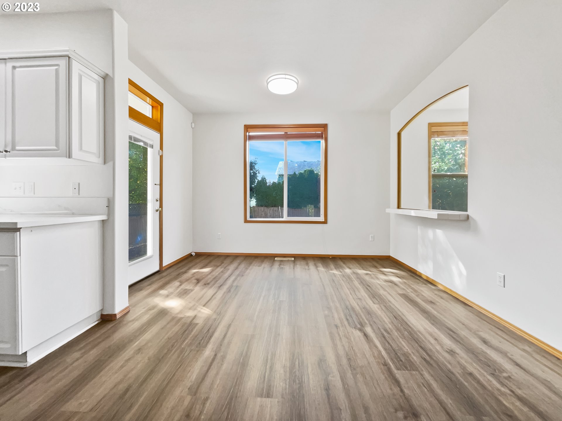 170 Southwest Sandlewood Loop Gresham, OR 97030 - Photo 8 of 19 an empty room with wooden floor and windows