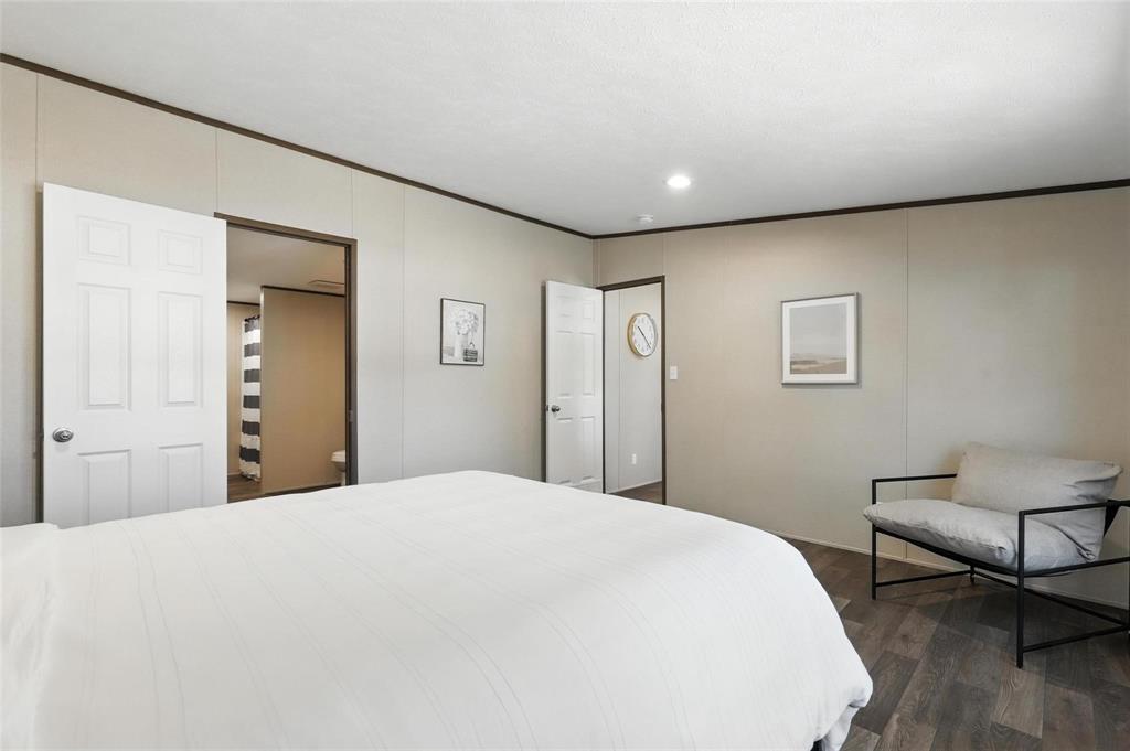 131 Kelly Court Azle, TX 76020 - Photo 14 of 22 a spacious bedroom with a bed and a chair