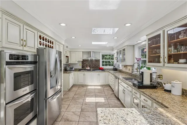 a large kitchen with stainless steel appliances lots of counter top space