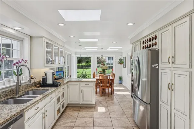 a kitchen with granite countertop a refrigerator and a sink