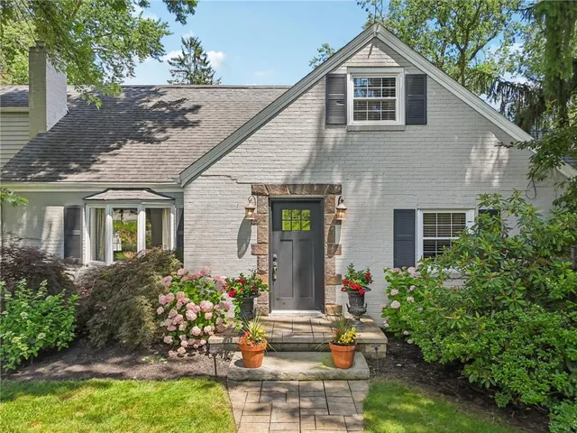 a front view of house with yard and green space