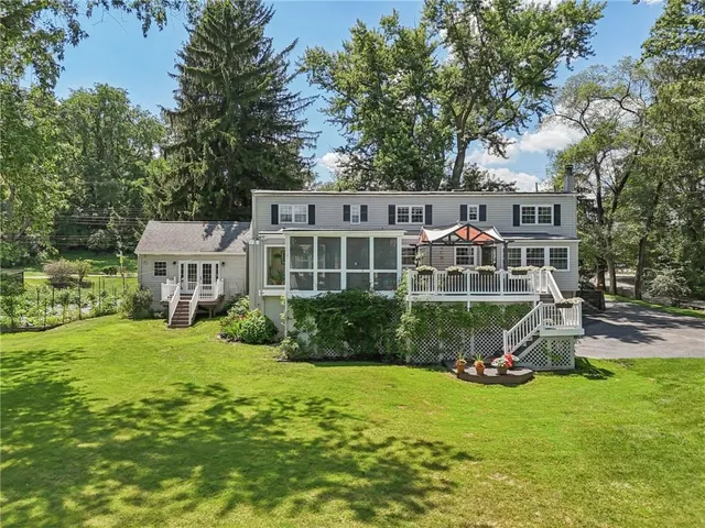 a view of a house with a yard and sitting area