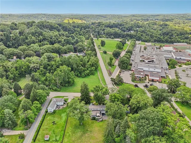 an aerial view of a house with lots of trees