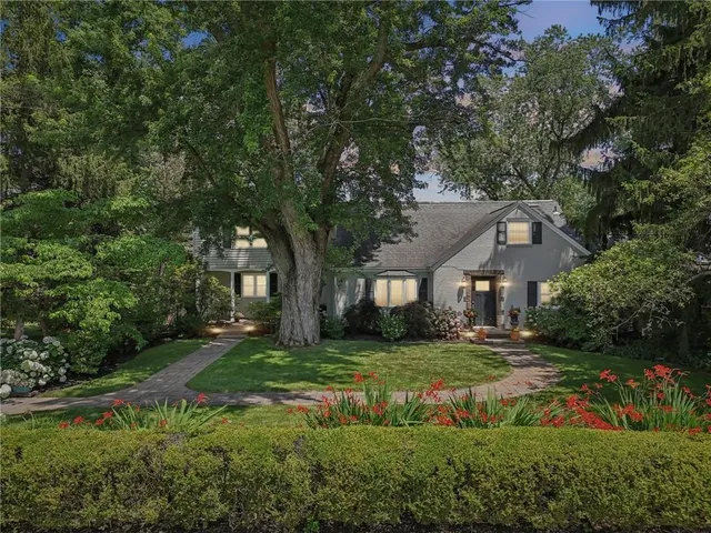 a front view of a house with a garden