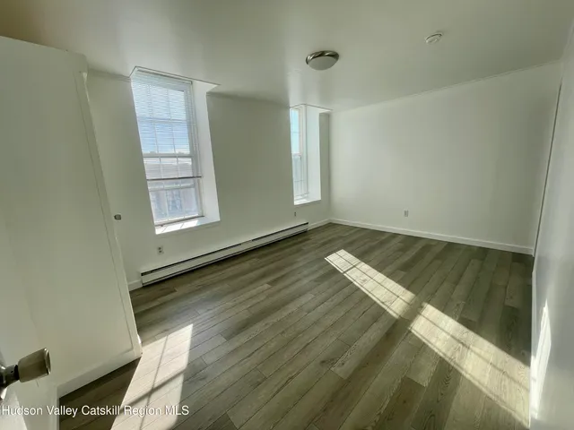 a view of wooden floor and windows in a room