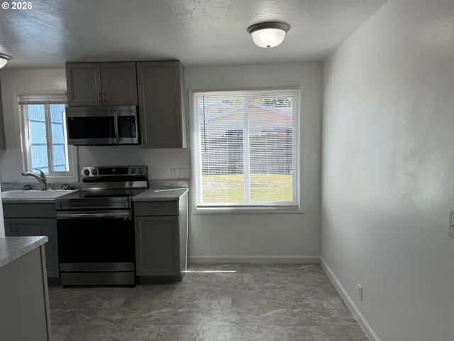 a kitchen with a stove and a microwave