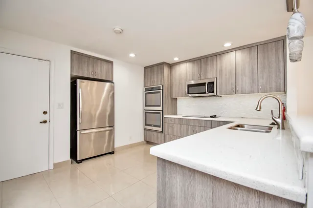 a kitchen with refrigerator and microwave