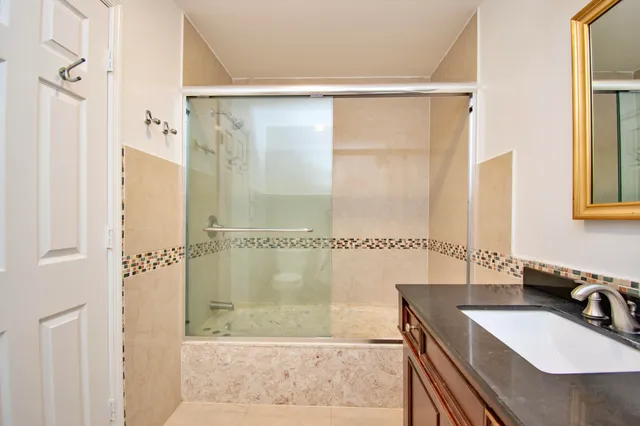 a bathroom with a sink mirror toilet and bathtub