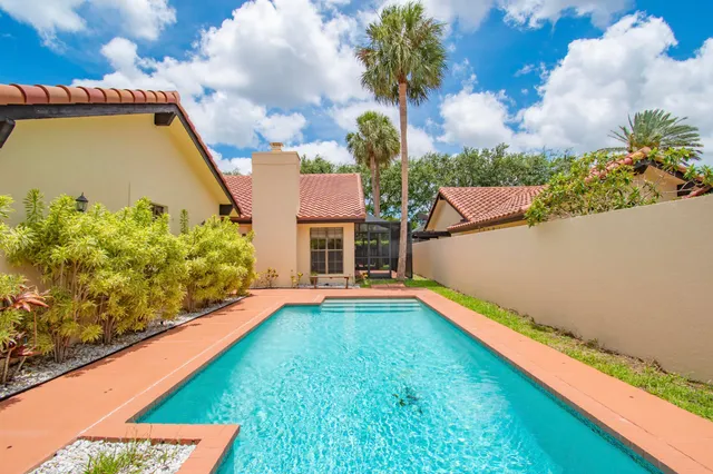 a view of a backyard with swimming pool