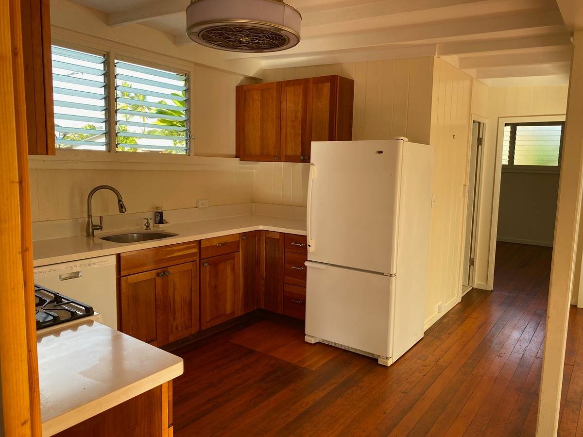 2916 Pala Street, Unit 13 Lihue, HI 96766 - Photo 4 of 11 a kitchen with a refrigerator sink and cabinets