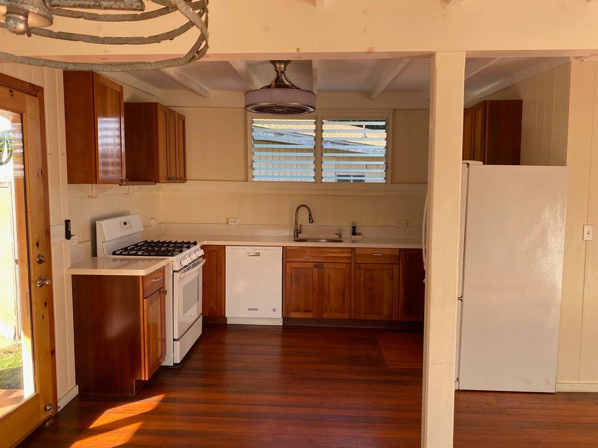 2916 Pala Street, Unit 13 Lihue, HI 96766 - Photo 5 of 11 a kitchen with stainless steel appliances granite countertop a sink and a stove with wooden floor