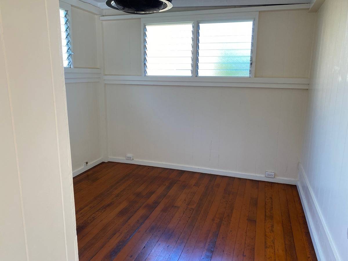 2916 Pala Street, Unit 13 Lihue, HI 96766 - Photo 10 of 11 an empty room with wooden floor and windows