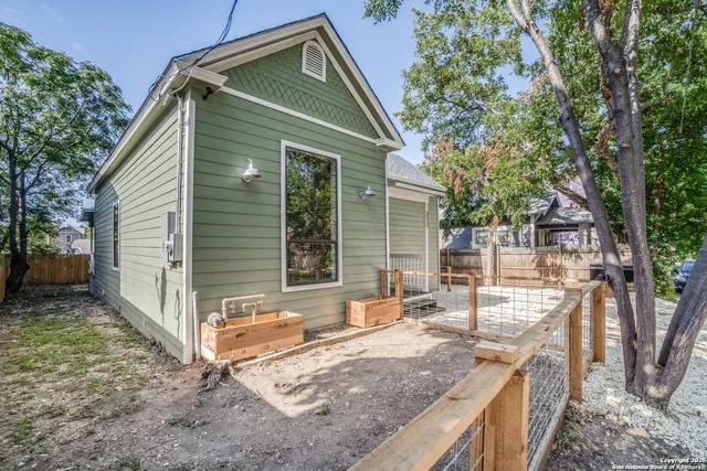 a view of a house with backyard and sitting area