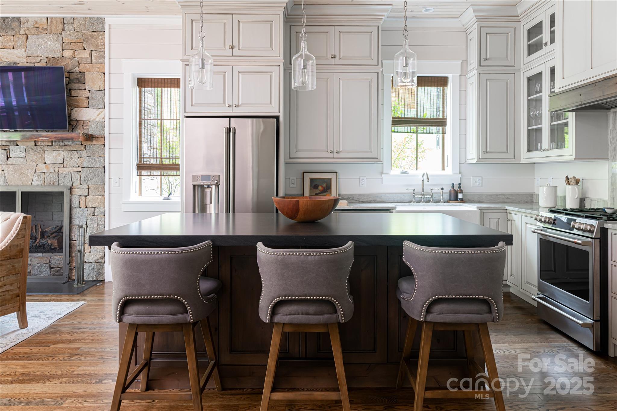 23 ( 1) Lodestone Drive, Unit 412 Sylva, NC 28779 - Photo 4 of 35 a kitchen with stainless steel appliances granite countertop a stove top oven a sink a dining table and chairs