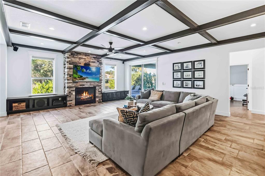 1004 Vinsetta Circle Winter Garden, FL 34787 - Photo 13 of 64 a living room with furniture a fireplace and a flat screen tv