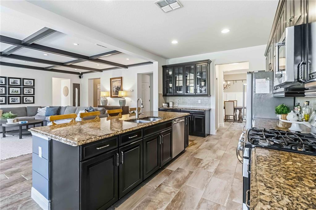 1004 Vinsetta Circle Winter Garden, FL 34787 - Photo 17 of 64 a kitchen with stainless steel appliances granite countertop lots of counter top space and wooden floors