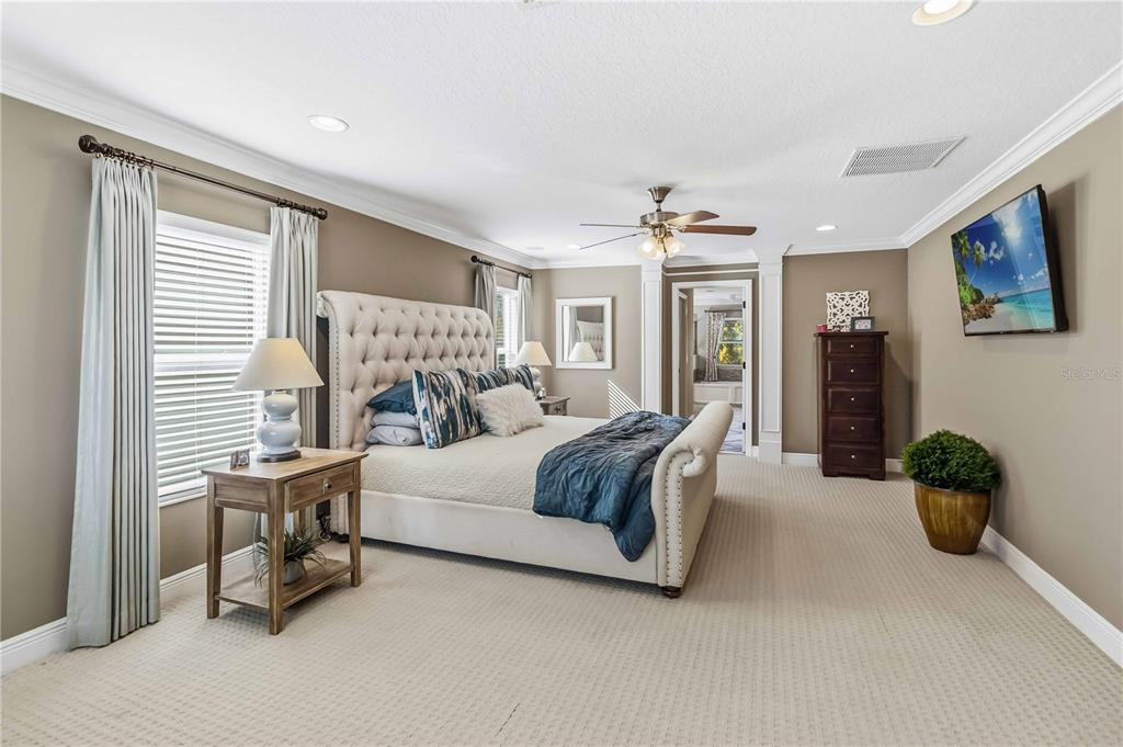 1004 Vinsetta Circle Winter Garden, FL 34787 - Photo 26 of 64 a bedroom with a bed and a chandelier