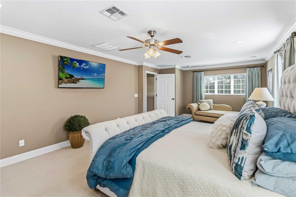 1004 Vinsetta Circle Winter Garden, FL 34787 - Photo 28 of 64 a bedroom with a bed and a painting on the wall