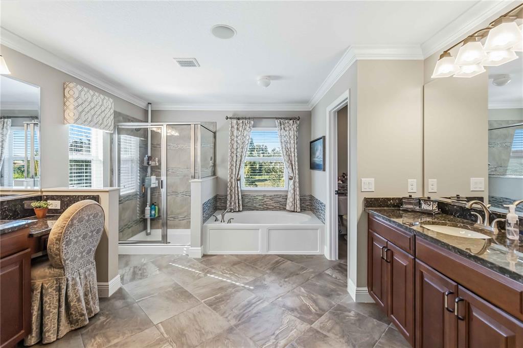 1004 Vinsetta Circle Winter Garden, FL 34787 - Photo 29 of 64 a spacious bathroom with a tub sink and mirror