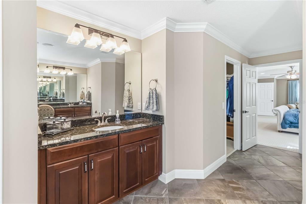 1004 Vinsetta Circle Winter Garden, FL 34787 - Photo 31 of 64 a bathroom with a granite countertop sink and a mirror