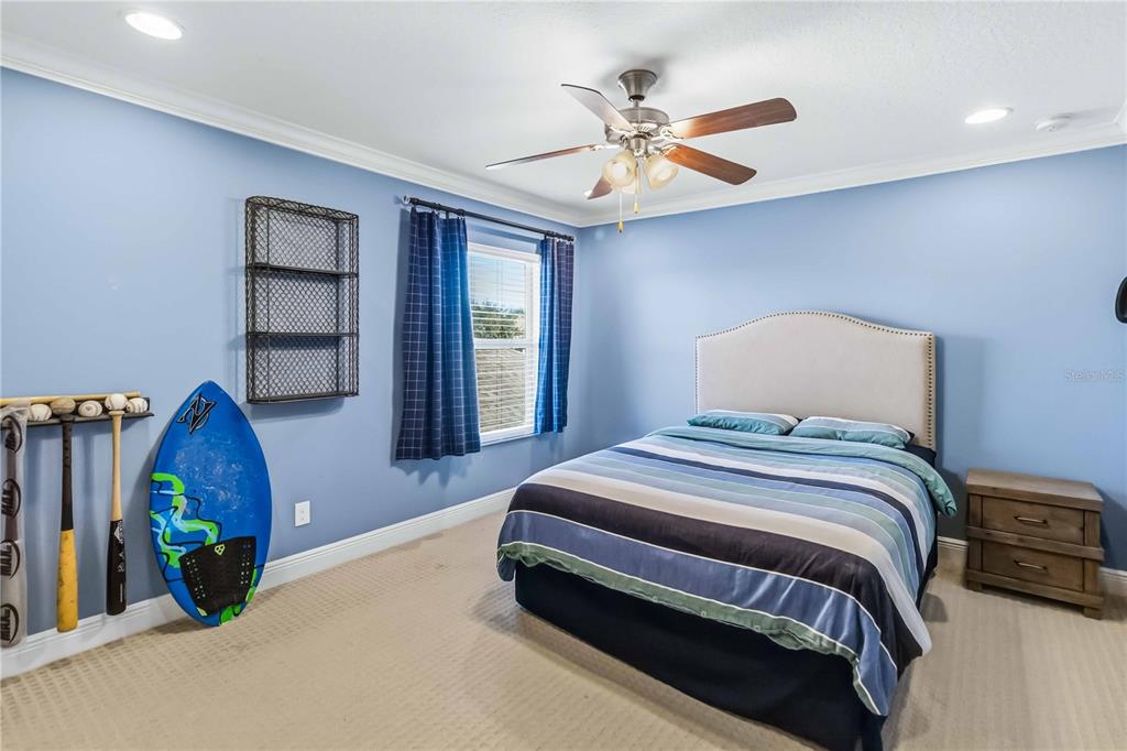 1004 Vinsetta Circle Winter Garden, FL 34787 - Photo 35 of 64 a bedroom with a bed and a chandelier