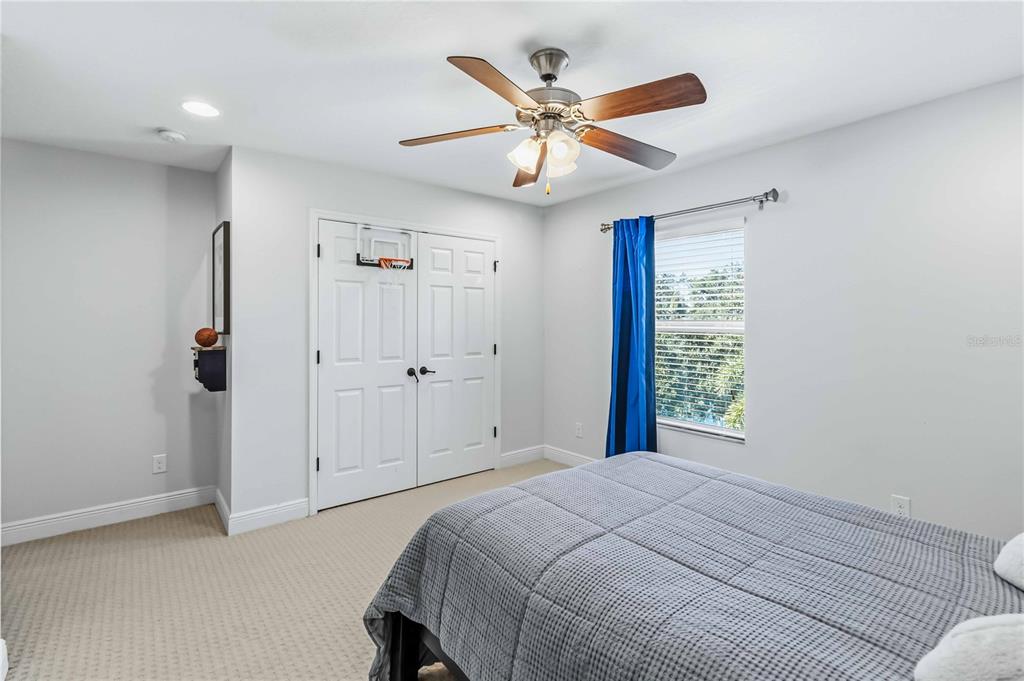 1004 Vinsetta Circle Winter Garden, FL 34787 - Photo 38 of 64 a bedroom with a large bed and a chandelier