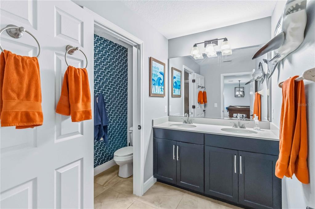 1004 Vinsetta Circle Winter Garden, FL 34787 - Photo 39 of 64 a bathroom with a sink a toilet and shower curtain